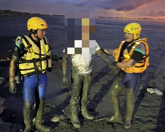 ▲遊客拍海堤夕陽深陷泥灘消防搶救。（圖／民眾提供）