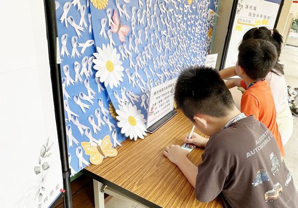 ▲校方在校園角落設置「讓祝福隨白絲帶飄揚」，讓學生自發性地寫下祝福與追思小卡片。（圖／普仁國小提供）