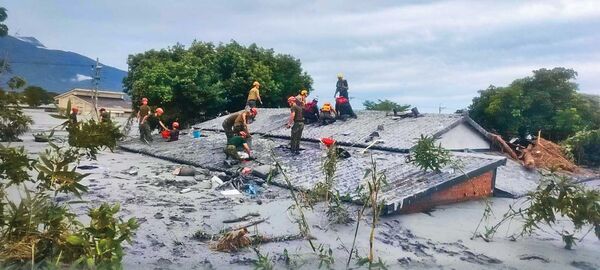 黑色土石泥流淹沒民宅，只剩屋頂可見，淤積厚度近3公尺。（翻攝花蓮縣政府臉書）
