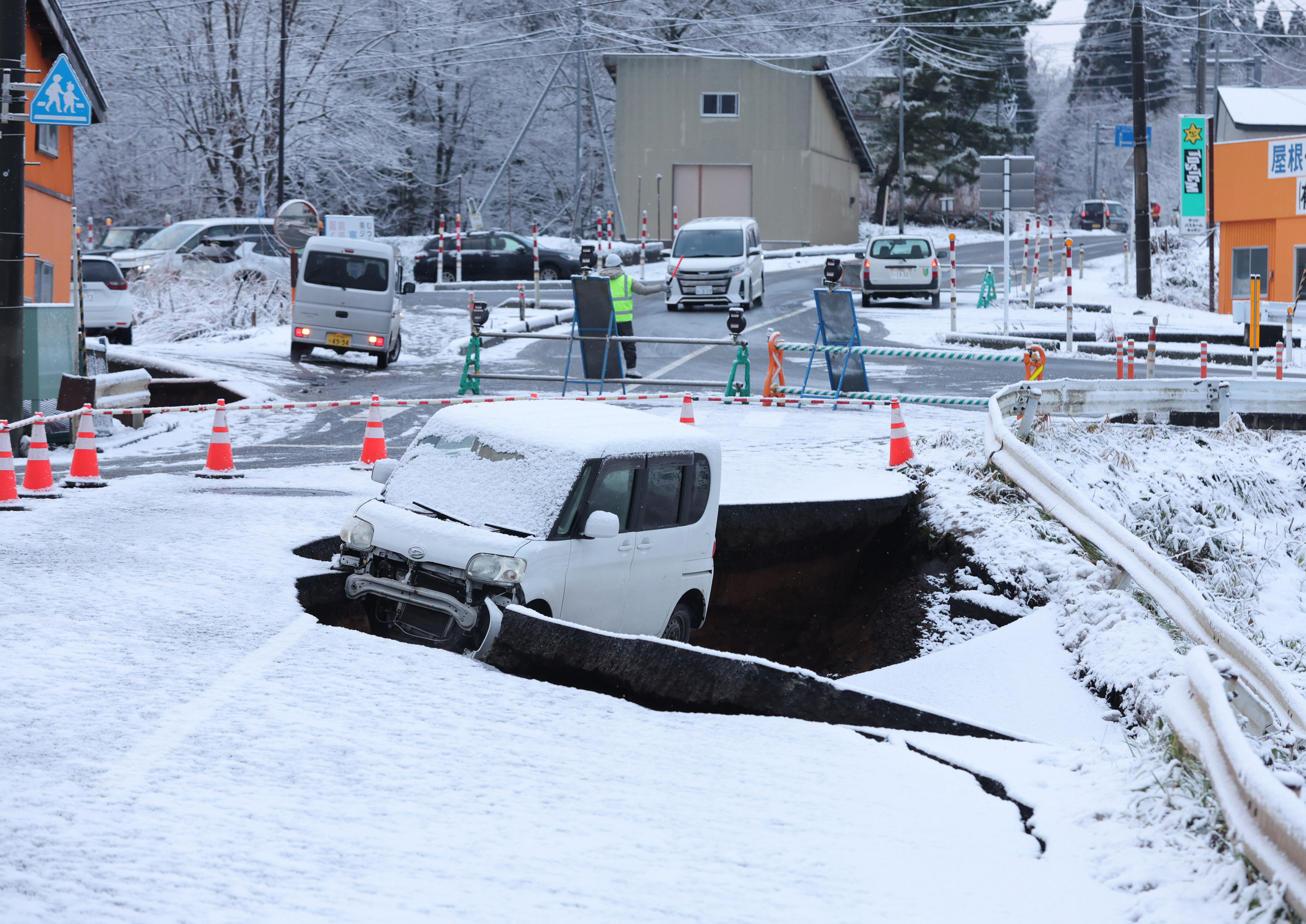 ▲路面出現大裂縫，自小客車墜入。（圖／達志影像）