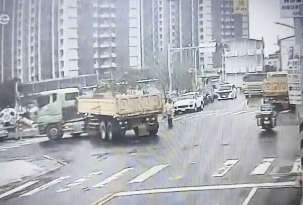 ▲桃園市龜山區興達路上一處工地，昨天上午一輛砂石車倒車載貨時，不慎輾過路口交通疏導林姓義交，圖為肇事前瞬間畫面曝。（圖／龜山警方提供）