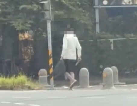 ▲男子精神恍惚持雙刀逛大街。（圖／民眾提供）