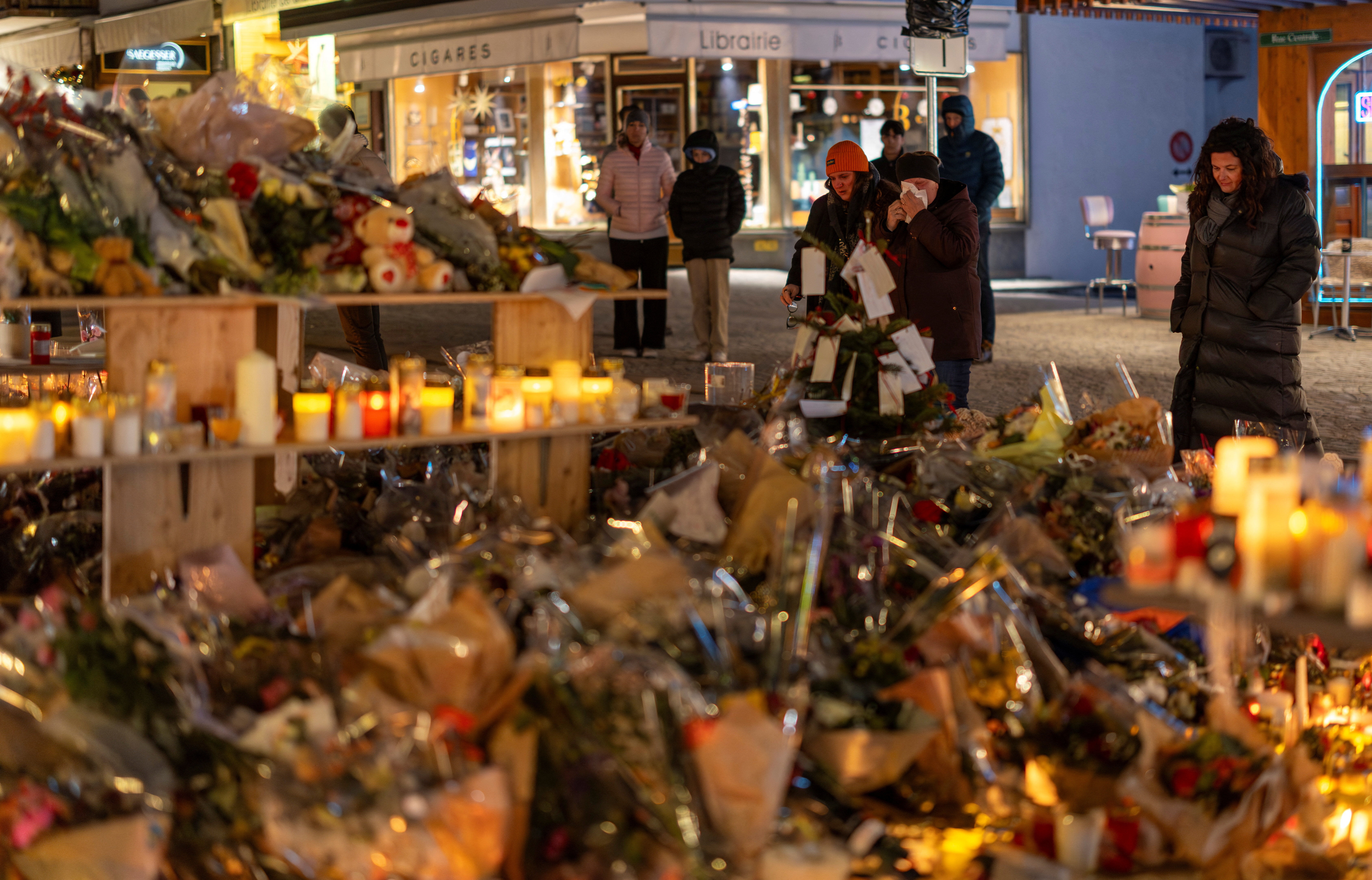 ▲▼瑞士滑雪勝地克蘭蒙丹納跨年夜酒吧爆炸引發火災,民眾在現場悼念。(圖/路透)