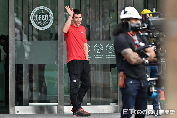 ▲▼美國自由攀岩名將霍諾德（Alex Honnold）於台灣時間25日挑戰徒手攀登台北101，歷時一個半小時成功登頂，在攀爬開始前他仍一派輕鬆地對在周圍守候的民眾揮手致意。（圖／記者李毓康攝）