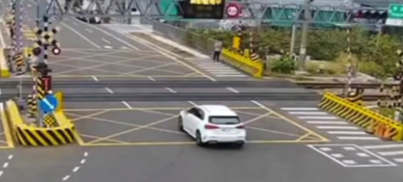 ▲白色轎車行經康橋大道平交道時，無視警鈴與閃光號誌，直接闖越，畫面驚險。（圖／翻攝自threadsacedra2046_）