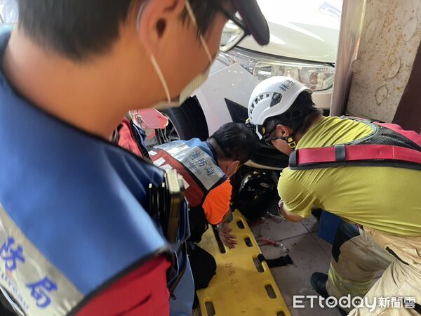 ▲台南安平老街附近12日下午發生車禍，1名50多歲男子遭自小客車壓住受困，消防人員全力搶救。（記者林東良翻攝，下同）